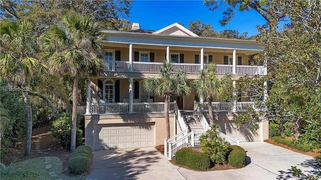 coastal inspired home featuring a garage and a porch