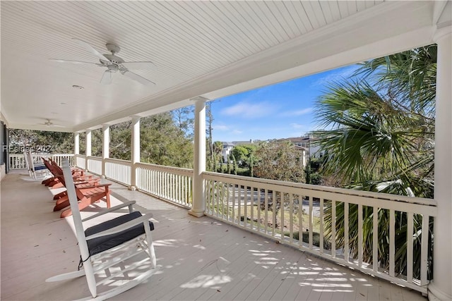 wooden deck featuring ceiling fan