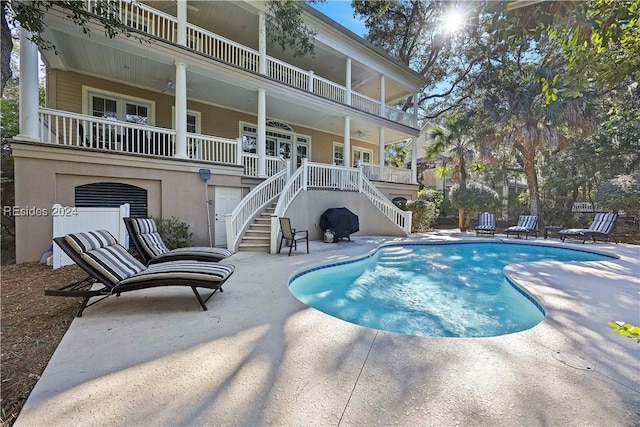 view of pool with a patio and ceiling fan