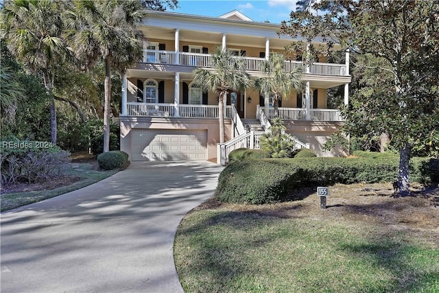 view of front facade featuring a garage, a balcony, and a porch