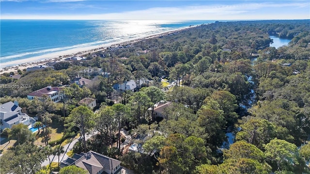 birds eye view of property with a water view and a beach view