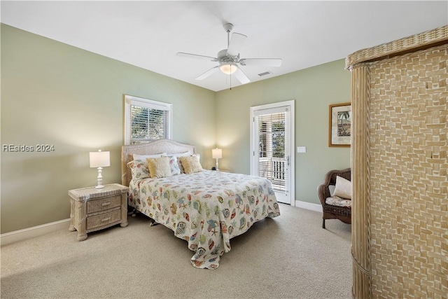 carpeted bedroom with multiple windows, access to exterior, and ceiling fan