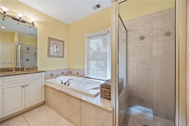 bathroom with vanity, tile patterned floors, and plus walk in shower