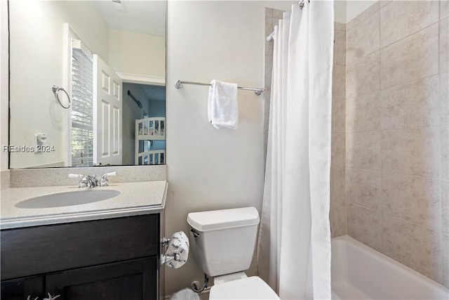 full bathroom featuring shower / bathtub combination with curtain, vanity, and toilet