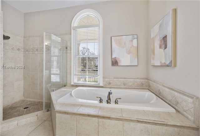 bathroom with tile patterned flooring and separate shower and tub