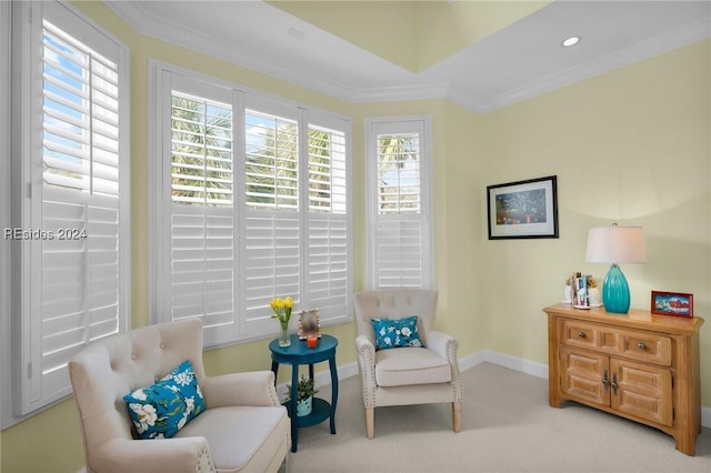 sitting room with crown molding and light colored carpet