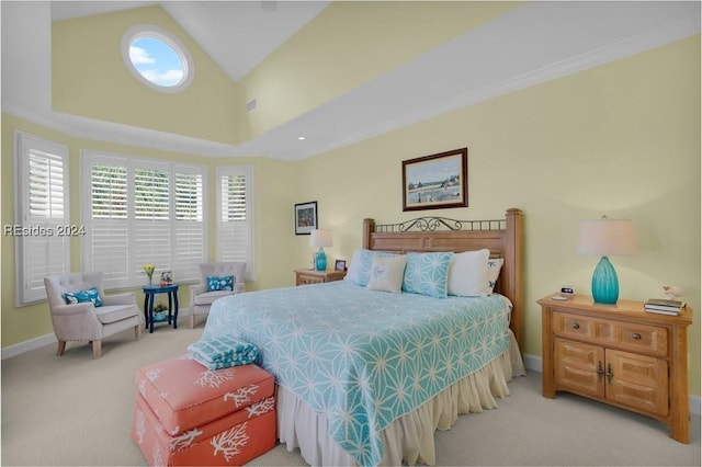 bedroom featuring light colored carpet and high vaulted ceiling