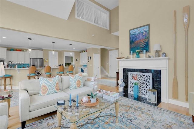 living room featuring a premium fireplace and light hardwood / wood-style floors