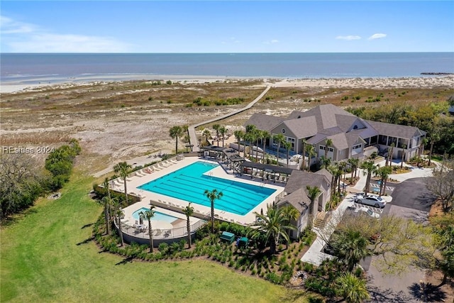 drone / aerial view with a beach view and a water view