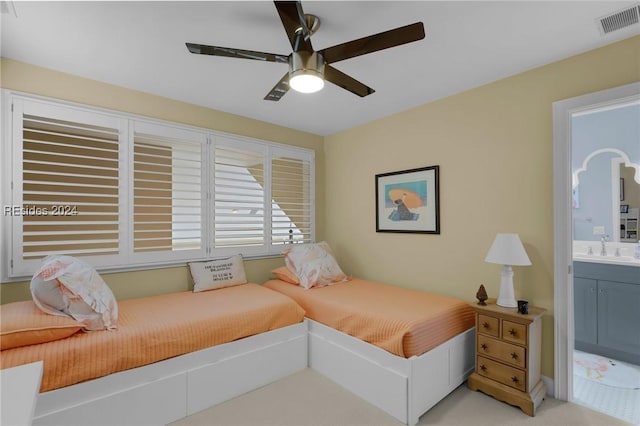 bedroom with sink, connected bathroom, and ceiling fan