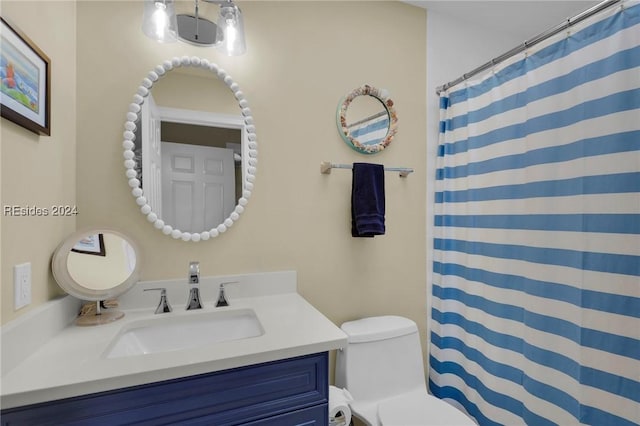 bathroom with vanity, a shower with shower curtain, and toilet