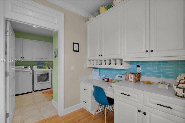 laundry area featuring ornamental molding, washer and dryer, and light tile patterned flooring