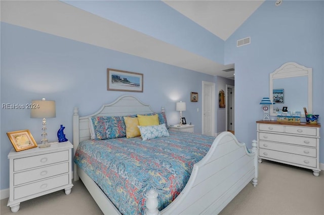 carpeted bedroom with vaulted ceiling