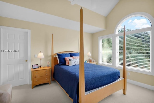 bedroom featuring vaulted ceiling and carpet