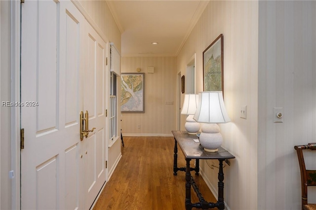 corridor with hardwood / wood-style floors and crown molding