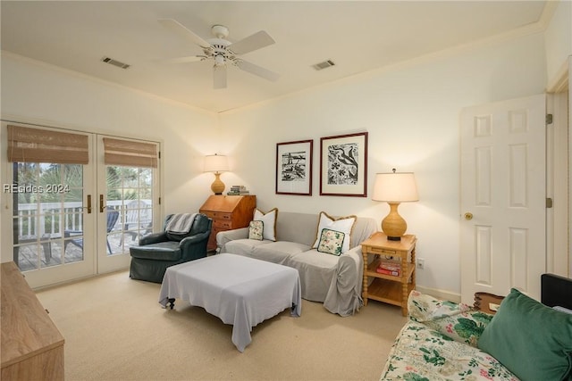 living room featuring french doors, ceiling fan, and light carpet