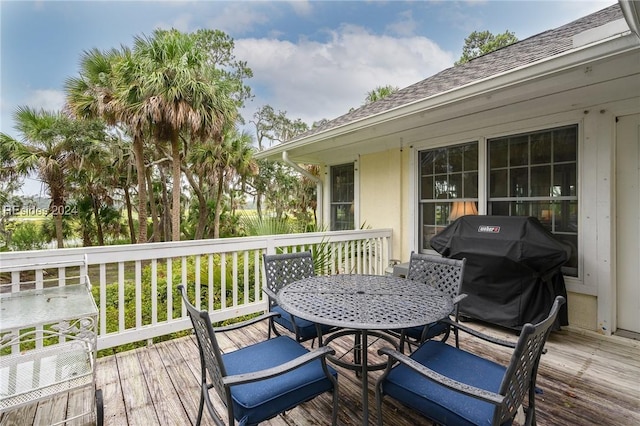 wooden deck featuring a grill