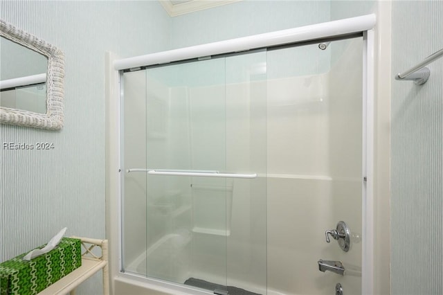 bathroom with bath / shower combo with glass door