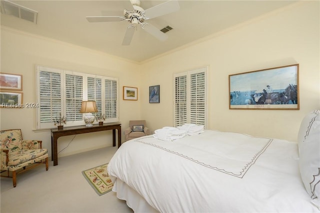 bedroom with crown molding, carpet floors, and ceiling fan