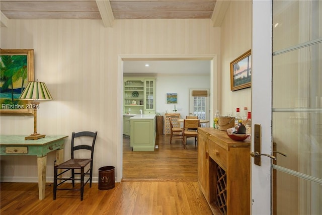 corridor with beamed ceiling and light hardwood / wood-style flooring