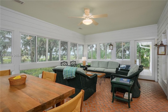 sunroom / solarium featuring ceiling fan and a wealth of natural light