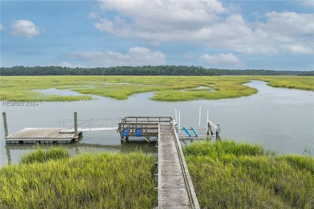 view of dock with a water view and a rural view