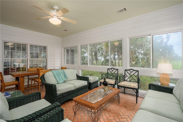 sunroom featuring ceiling fan