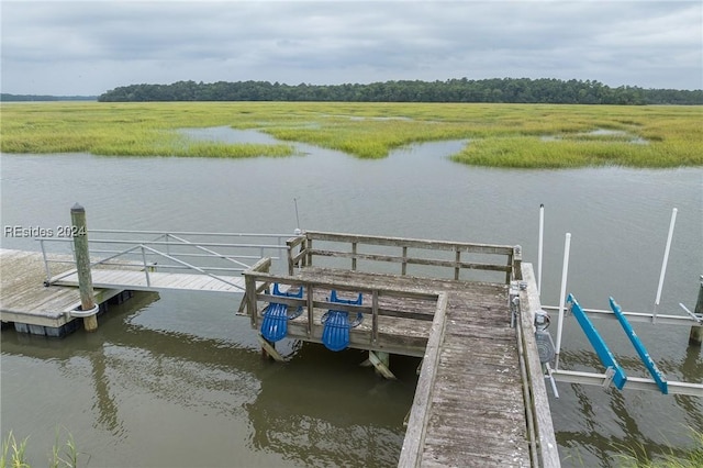 view of dock featuring a rural view and a water view