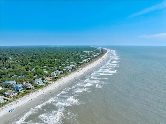 bird's eye view with a water view and a beach view