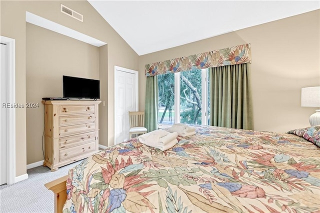 carpeted bedroom with lofted ceiling