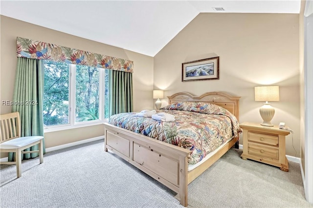 carpeted bedroom with vaulted ceiling