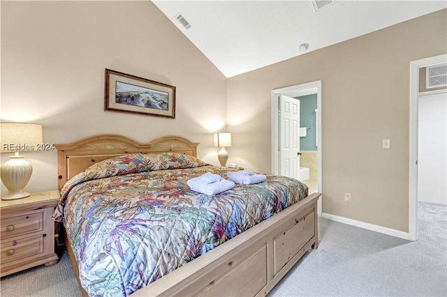 carpeted bedroom featuring lofted ceiling and connected bathroom