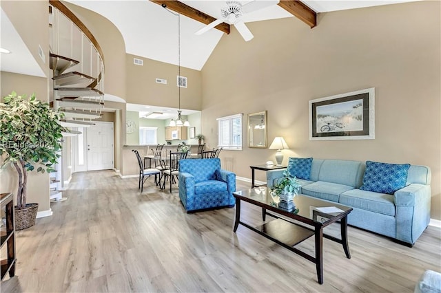 living room featuring ceiling fan, light hardwood / wood-style flooring, high vaulted ceiling, and beamed ceiling