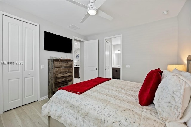 bedroom with connected bathroom, light hardwood / wood-style flooring, a closet, and ceiling fan