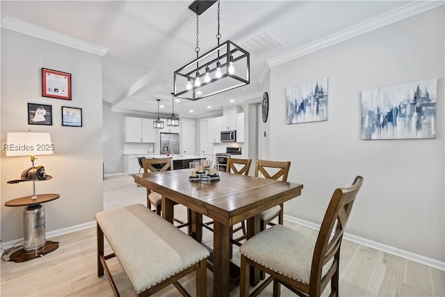 dining room featuring light hardwood / wood-style flooring and ornamental molding