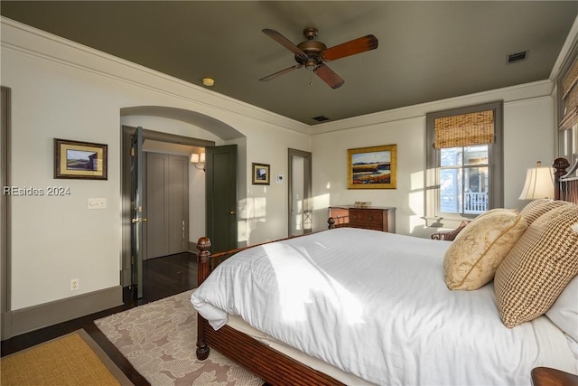 bedroom with crown molding, dark hardwood / wood-style floors, and ceiling fan