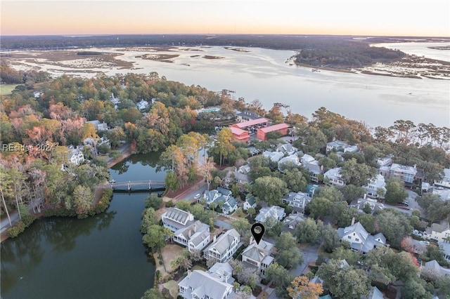 aerial view at dusk with a water view