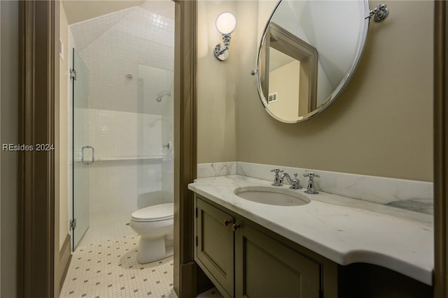 bathroom featuring vanity, an enclosed shower, and toilet