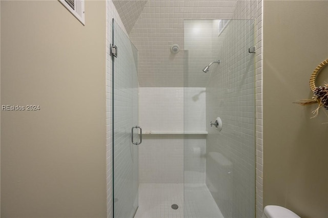 bathroom featuring a shower with shower door