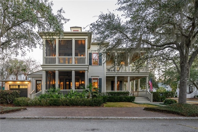 view of front of home with a sunroom and a balcony