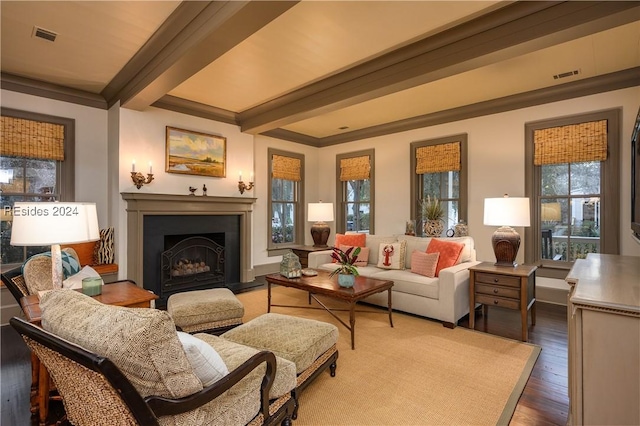 living room featuring hardwood / wood-style flooring, ornamental molding, and beamed ceiling