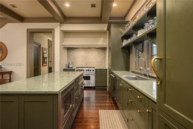 kitchen featuring sink, stainless steel appliances, light stone countertops, a kitchen island, and decorative backsplash