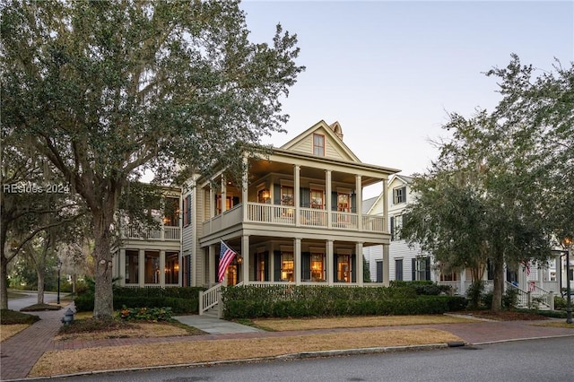 greek revival house featuring a balcony