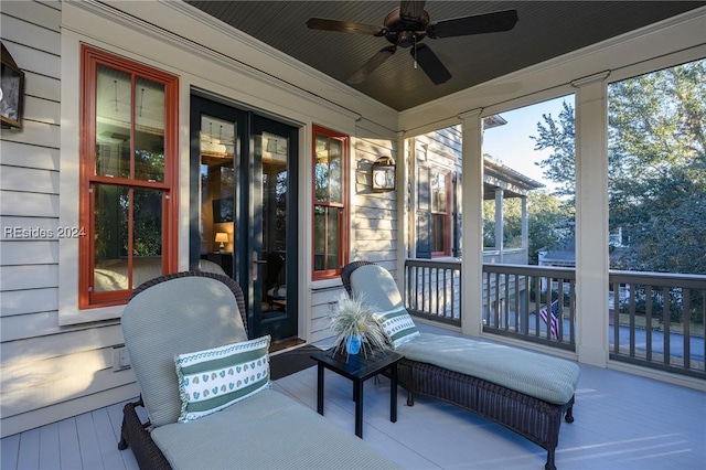 sunroom / solarium featuring plenty of natural light and ceiling fan