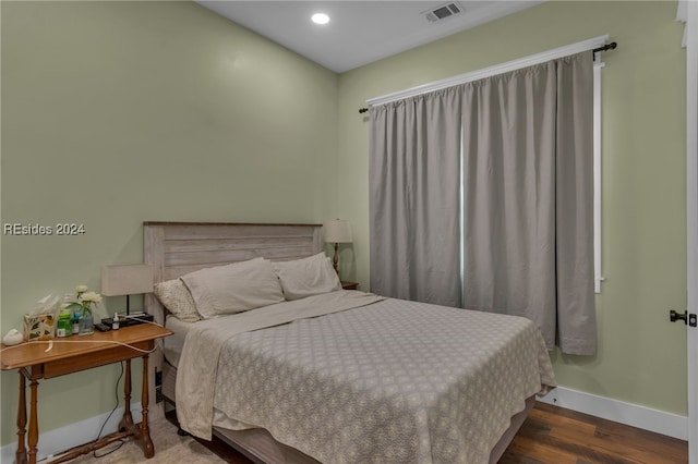 bedroom with dark wood-type flooring