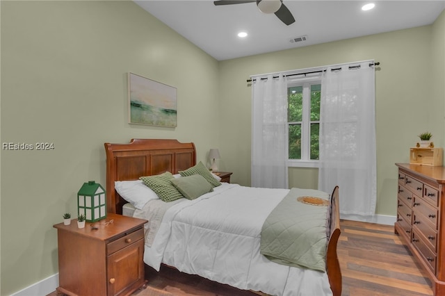 bedroom with dark hardwood / wood-style flooring and ceiling fan