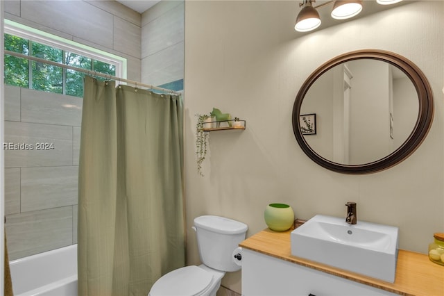 full bathroom featuring shower / tub combo with curtain, sink, and toilet