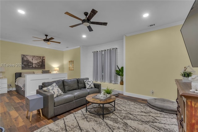 living room with ornamental molding, dark wood-type flooring, and ceiling fan