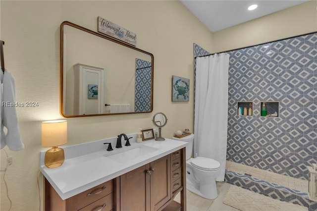 bathroom with vanity, curtained shower, and toilet