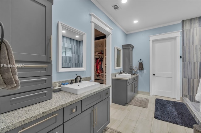 bathroom featuring tile patterned floors, ornamental molding, and vanity